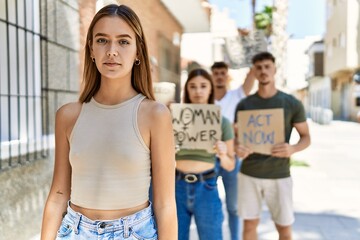 Group of people protesting and giving slogans at the street thinking attitude and sober expression looking self confident
