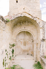 Arch of an old sand stone brick chapel and castle in the picturesque village Le-Po&euml;t-Laval in the south of France