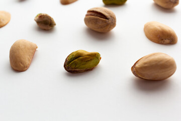 Close up of roasted pistachios isolated on white background.