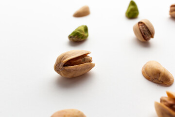 Close up of roasted pistachios isolated on white background.