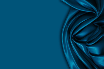 Beautiful elegant wavy dark blue satin silk luxury cloth fabric with monochrome background design. Copy space