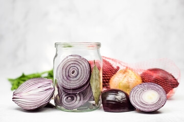 Cooking pickled red onion in glass jar. Selective focus. Copy space.