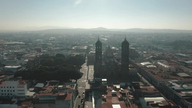 Aerial view showing silhouette of famous Puebla Cathedral and and cityscape of City in Mexico during sunlight