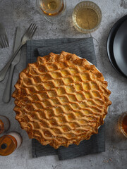 English meat pie. Pork pie. Traditional British pie. Freshly baked homemade savory pies with golden crust. Pie with pastry decoration on top. Food photography, food styling.