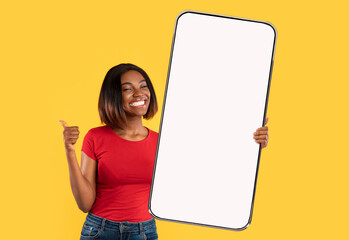 Black lady showing big white empty smartphone screen and like