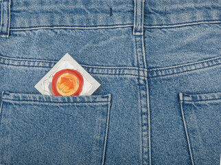 Condom in the pocket of a blue jeans