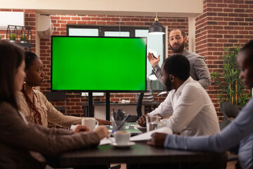 Executive manager man explaining marketing strategy using mock up green screen chroma key monitor...