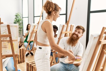 Group of people smiling happy drawing at art studio.