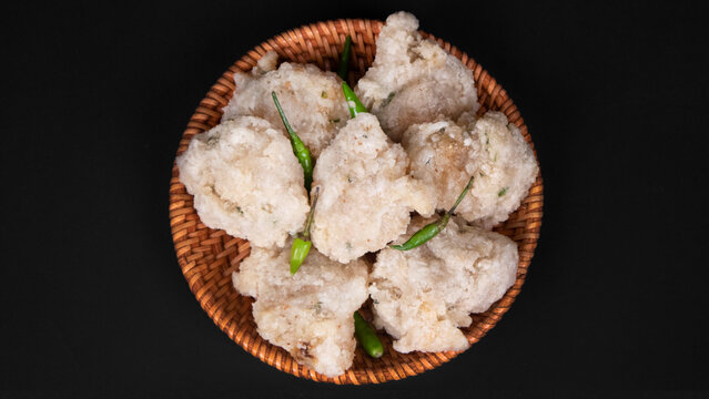 a bowl of fried tapioka flour in a black background