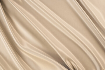 Fototapeta na wymiar Beautiful elegant wavy beige / light brown satin silk luxury cloth fabric texture, abstract background design. Copy space. Card or banner