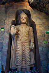 Large stone statue of Buddha in a cave in Golden Mount or Wat Saket (Golden Mountain)