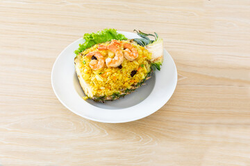 Fried rice with seafood served in a pineapple.