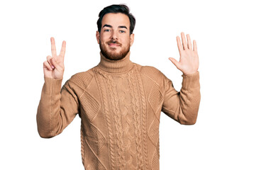 Fototapeta premium Young hispanic man wearing casual clothes showing and pointing up with fingers number seven while smiling confident and happy.