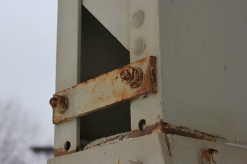 Heavy steel bolt holding a plate.