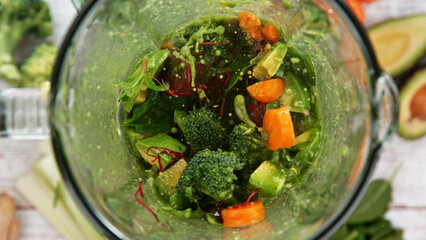 Mixing pieces of Vegetables in blender, top view.
