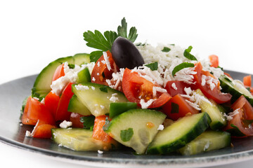 Traditional Bulgarian shopska salad with tomato,cucumber and bulgarian sirene cheese isolated on white background	