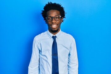 Young african american man wearing business clothes with a happy and cool smile on face. lucky person.