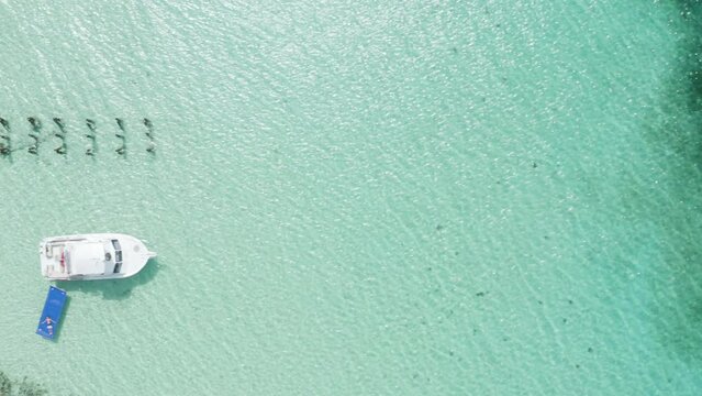 AERIAL - Boat on clear turquoise waters, Cayo Icacos, Puerto Rico, top down truck left