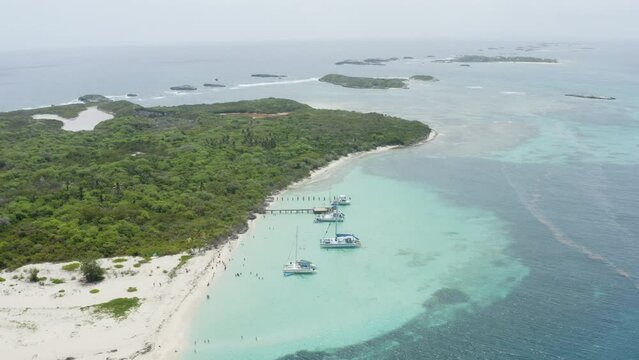 AERIAL - Overview of boats and island, Cayo Icacos, Puerto Rico, high angle pan right