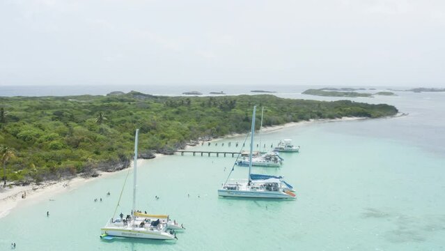 AERIAL - People on boats on clear waters, Cayo Icacos, Puerto Rico, rising circle pan