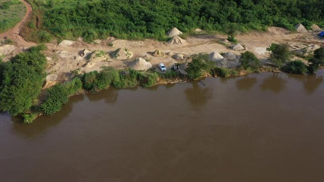 Aerial Sewa River diamond mining area Sierra Leone circle part 1. West Africa suffers extreme poverty and hunger. Forest jungle landscape environment. Congested crowded homes tropical climate.