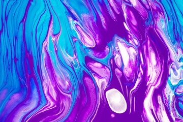 Fluid art texture. Background with abstract mixing paint effect. Liquid acrylic artwork with flows and splashes. Mixed paints for baner or wallpaper. Purple, blue and white overflowing colors.