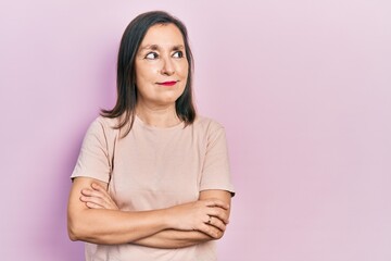 Fototapeta premium Middle age hispanic woman with arms crossed gesture smiling looking to the side and staring away thinking.