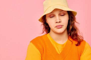 portrait of a young woman orange sweater emotions fun cropped view unaltered