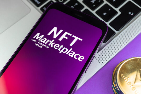 NFT cryptoart marketplace concept. Mobile phone for working with non-fungible token. Future of crypto currency, blockchain technology. Office table with laptop and ethereum coin, top view photo