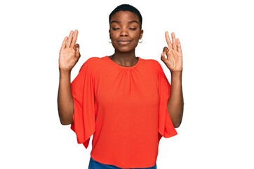 Young african american woman wearing casual clothes relax and smiling with eyes closed doing meditation gesture with fingers. yoga concept.