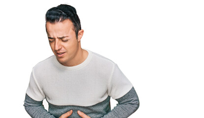 Fototapeta premium Handsome young man wearing casual winter sweater with hand on stomach because nausea, painful disease feeling unwell. ache concept.