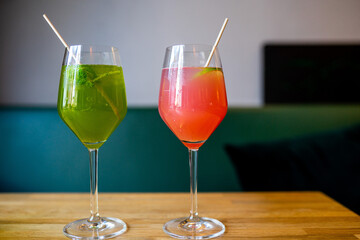 green and pink cocktails with lime on a table