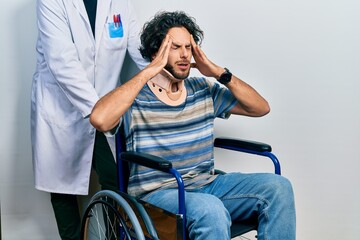 Handsome hispanic man sitting on wheelchair wearing neck collar with hand on head for pain in head...