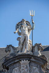  Statue of Poseidon in the city of Ghent with blue background © Tom