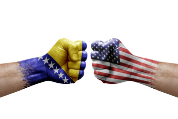 Two hands punch to each others on white background. Country flags painted fists, conflict crisis concept between bosnia and usa
