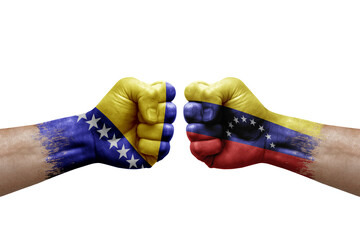 Two hands punch to each others on white background. Country flags painted fists, conflict crisis concept between bosnia and venezuela