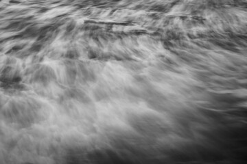 Black and white long exposure natural abstract background of sea water and waves moving.