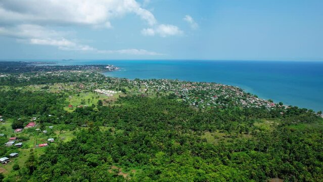 Aerial view towards the Pantufo town in sunny Sao Tome - approaching, drone shot