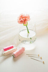 Threads, needles and airy fabric