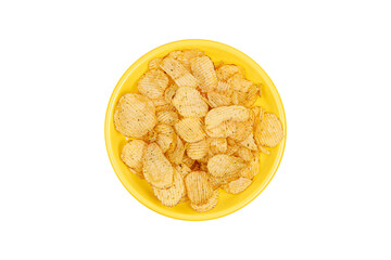 corrugated potato chips on a yellow plate isolated on white background. view from above