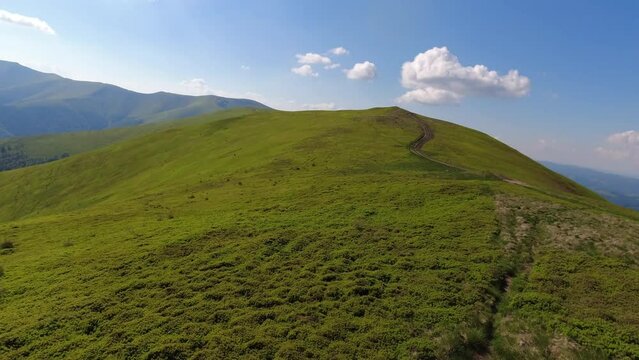 Aerial flight over green hill mountains. FPV Dynamic drone shot