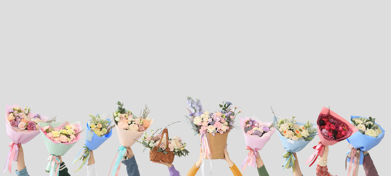 Flowers. Hands holding large bouquets of flowers.