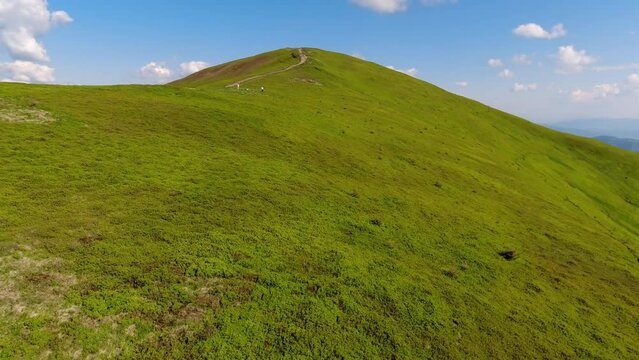 Aerial flight over green hill mountains. FPV Dynamic drone shot