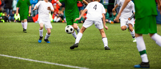 Soccer football duel moment. Two young soccer team on tournament match. Players compete in a game