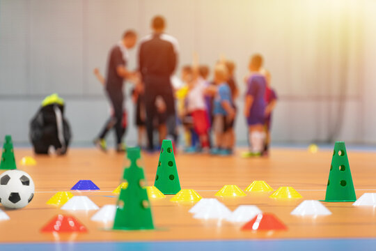 Futsal Soccer Training Court. Kids In A Group With Coaches In Blurred Background. Kids On Physical Education Class At School