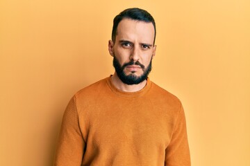 Young man with beard wearing casual winter sweater skeptic and nervous, frowning upset because of problem. negative person.