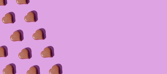 Heart shaped chocolates on a purple background. Modern Valentine day card with copy space for text