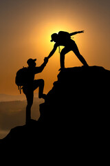 Two backpack Man  adventure travel concept.Help and assistance concept silhouette of two people climbing a mountain and helping