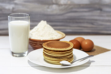 Pancakes with ingredients: flour, eggs, milk, soda