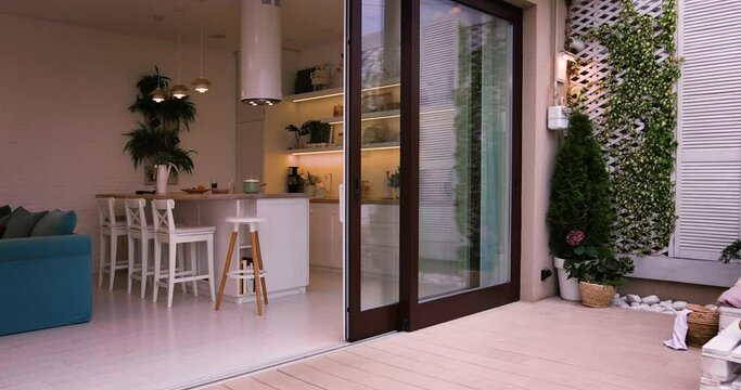 rooftop patio zone with sliding doors and open space kitchen at summer evening